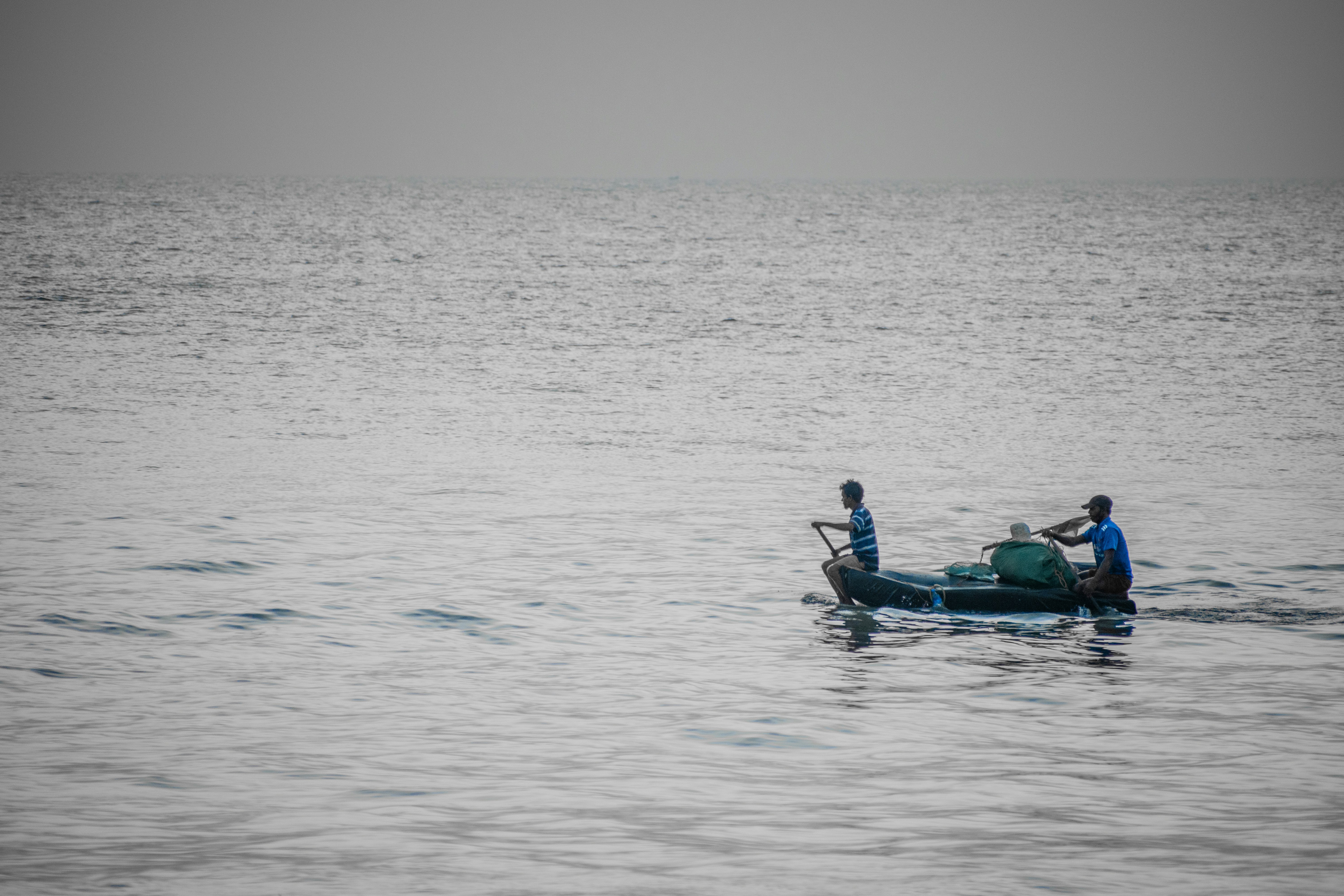 people riding on boat on sea during daytime